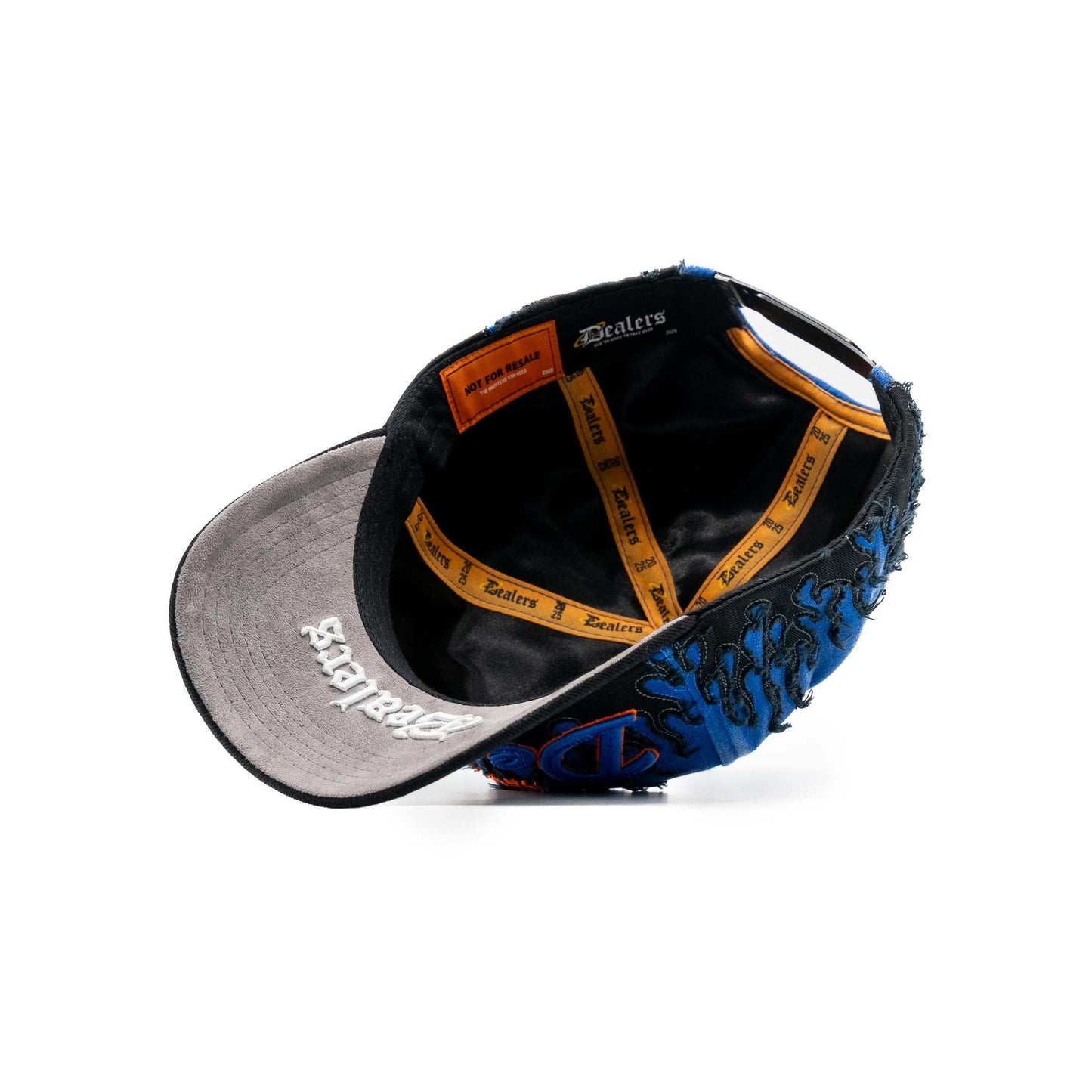 Inside view of blue and black embroidered snapback hat with flame pattern and unique branding.