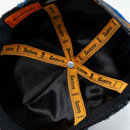 Inside of a black bucket hat with orange Dealers logo taping and a silver button.