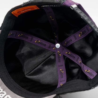 Inside view of a black hat with purple cross lining and logo details