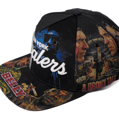 The Classics NY movie-collage snapback, flat brim — front angle with brim print