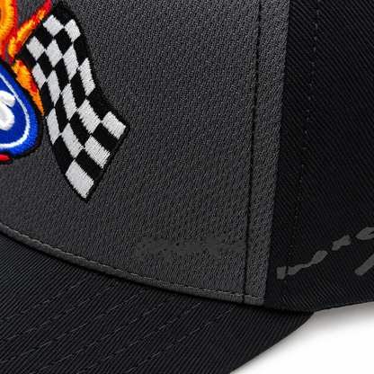 Close-up of the checkered flag embroidery on the textured charcoal front panel