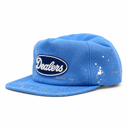 Dealers Unstructured Racing cap, three-quarter view — azure canvas, navy Dealers patch and paint splatter