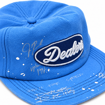 Close-up of the navy Dealers oval patch, white paint splatter and silver signatures