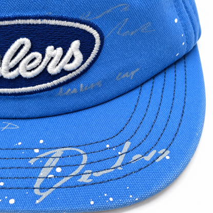 Close-up of the Dealers patch and hand-written marks on the stitched brim