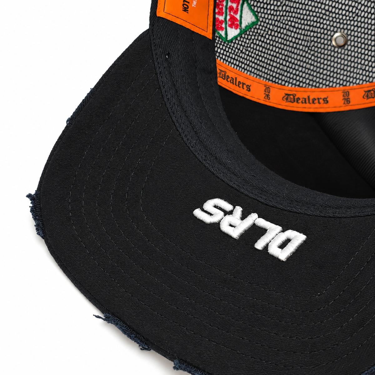 Under the brim of the Fast Life Racing Trucker — white DLRS embroidery and frayed edge
