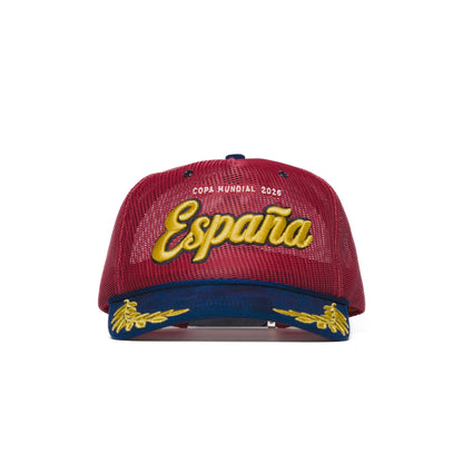 Front view of Spain trucker hat — The Hat Dealers — red mesh trucker with gold 'España' script embroidery and navy laurel brim