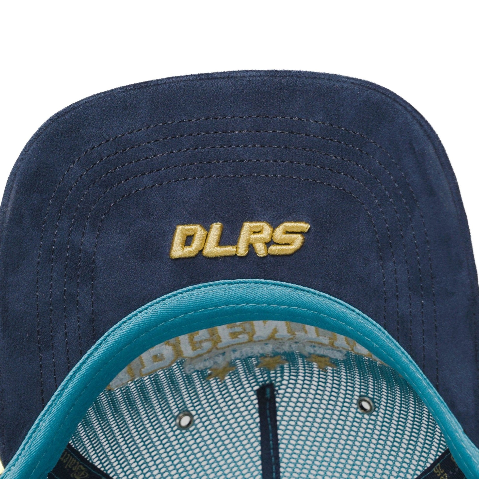 Underbrim detail of Argentina trucker hat with navy suede and gold DLRS embroidery — The Hat Dealers