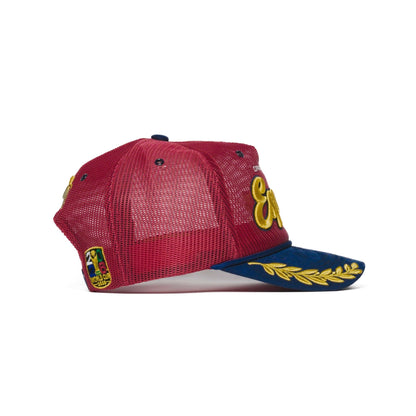 Right side profile of Spain trucker hat — The Hat Dealers — red mesh body with patch and gold-laurel brim