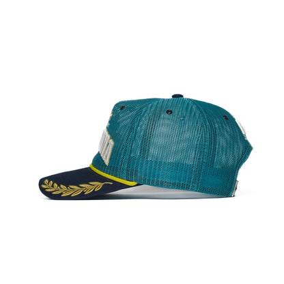 Left side view of Argentina trucker hat with navy brim and gold laurel embroidery — The Hat Dealers