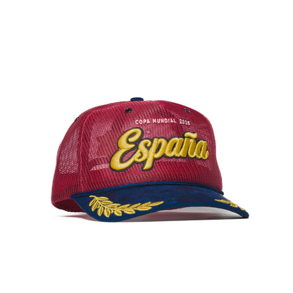 Left three-quarter angle of Spain trucker hat — The Hat Dealers — red crown, navy gold-laurel flat brim