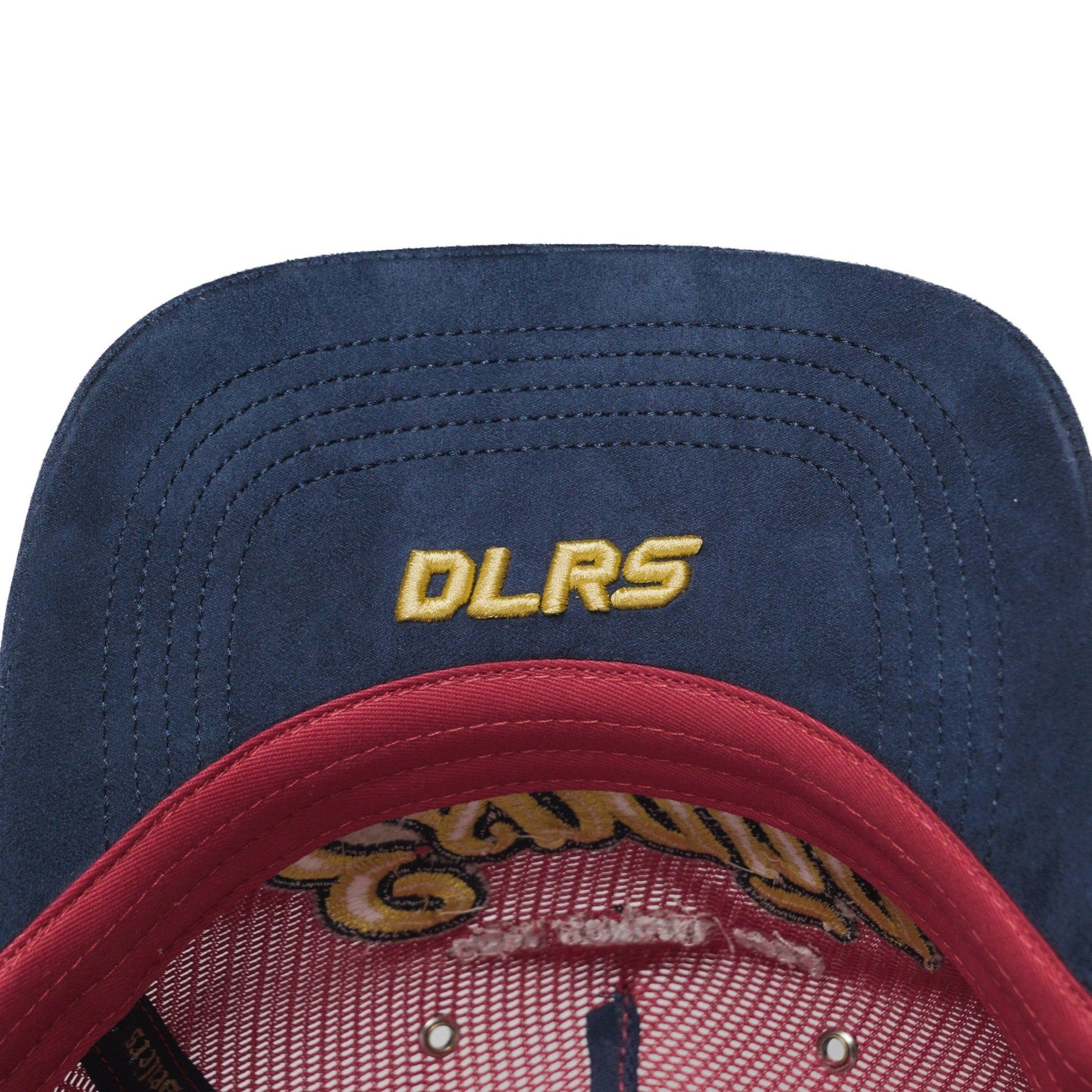 Underbrim detail of Spain trucker hat — The Hat Dealers — navy underside with gold DLRS embroidery