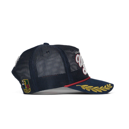 Back detail of USA trucker hat — The Hat Dealers — navy snap closure with white Dealers star crest and woven patch