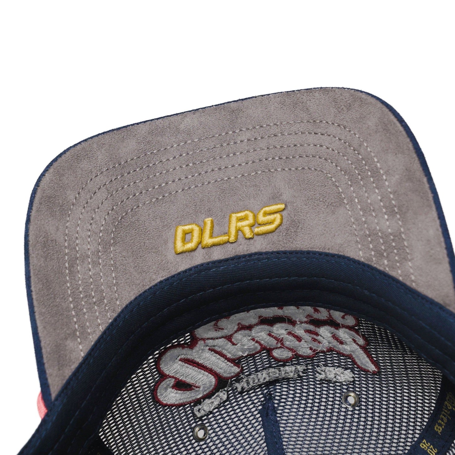 Underbrim detail of USA trucker hat — The Hat Dealers — navy underbrim with gold DLRS embroidery